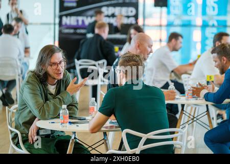 Moscow - April 10,2024: Professionals networking and engaging in discussions at business event Open Innovations Conference in Skolkovo Technopark at modern hall Stock Photo