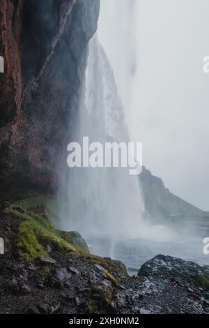 View from behind Seljalandsfoss waterfall in Iceland Stock Photo