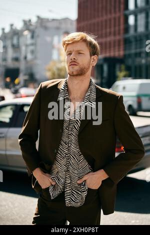 Red-haired man in stylish attire strolling down street. Stock Photo