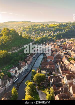 Small town view with river and bridge, surrounded by hills and forests on a sunny day, Calw, Black Forest, Germany Stock Photo