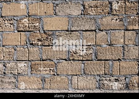 Background. Stone wall texture. The shell rock material is bonded with cement mortar Stock Photo