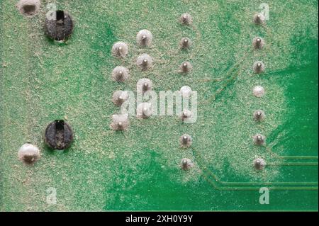 Electronic components close-up on an old computer motherboard. Dust on the surface of the parts Stock Photo