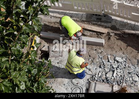 Construction workers working on sidewalk. City Maintenance concept Stock Photo