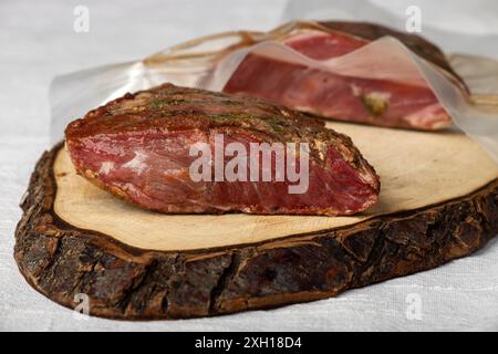 Pastrami meat on a wooden chopping board Stock Photo