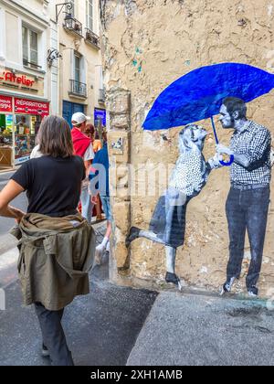 Photo montage mural of couple under blue umbrella on the Rue de la Verrerie, Paris 75004, France. Stock Photo