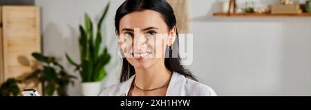 A stylish woman smiling at camera while working from home. Stock Photo