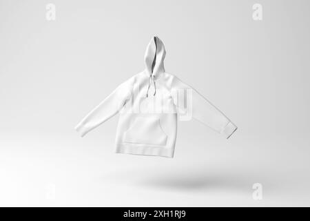 White hoodie floating in mid air on white background in monochrome and minimalism. Concept of youth fashion, hip hop culture and textile industry Stock Photo