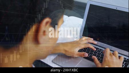 Image of globe and chart over student using laptop and cellphone in classroom. Digital composite, globalization, school, data, education, childhood, e Stock Photo