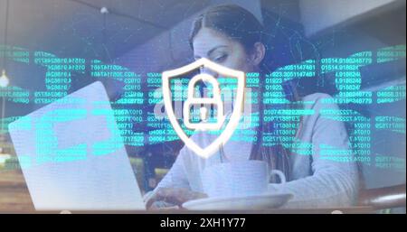 Image of padlock in shield, numbers in blockchain, connected dots, caucasian woman using laptop. Digital composite, multiple exposure, cryptocurrency, Stock Photo