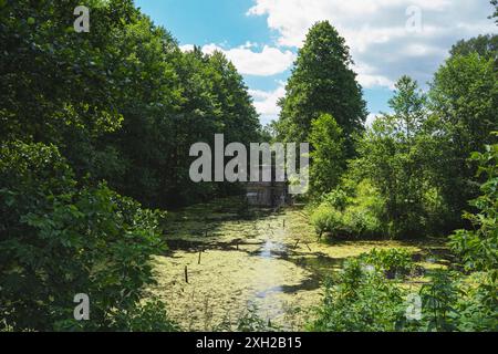 concrete wall of the old military fortress over water of oxbow lake Stock Photo