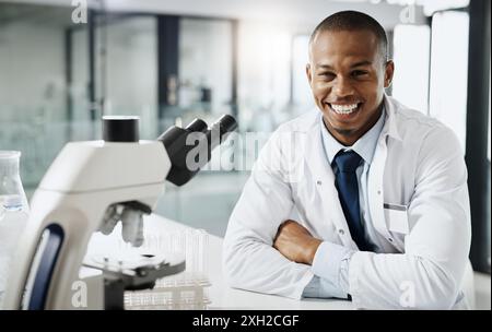 Smile, laboratory and portrait of black man with microscope, medical study and confidence in science. Biotech, research and happy scientist with Stock Photo