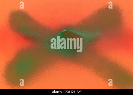x sign painted with green spray on orange paper background Stock Photo