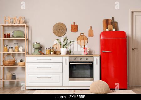 Interior of kitchen with red fridge, counters and shelving unit Stock ...