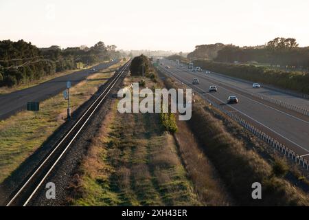 Traffic on Peka Peka to Otaki expressway, with train tracks and old state highway running parallel, in Kapiti, New Zealand Stock Photo