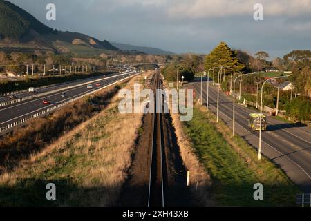 Traffic on Peka Peka to Otaki expressway, with train tracks and old state highway running parallel, in Kapiti, New Zealand Stock Photo