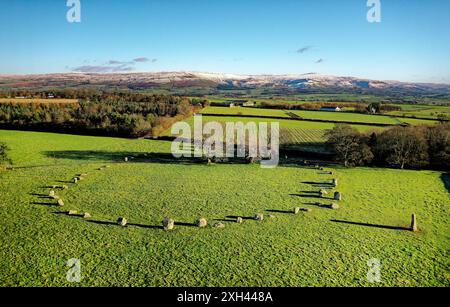 Long Meg and Her Daughters stone circle. Prehistoric Neolithic monument. Langwathby, Cumbria, UK. S.E. over Eden Valley to snow covered Pennines Stock Photo