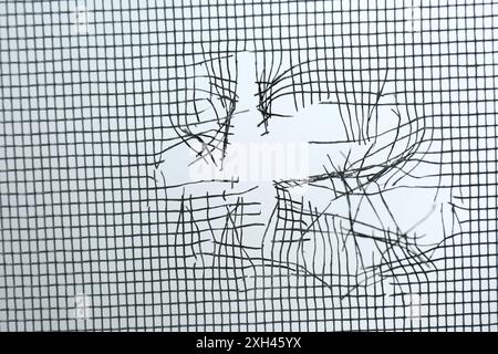 Torn window screen against white background, closeup Stock Photo