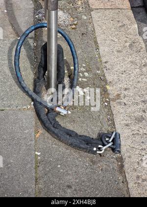 Abandoned Heavy Duty Bicycle Chain Locks on a Metal Post Stock Photo