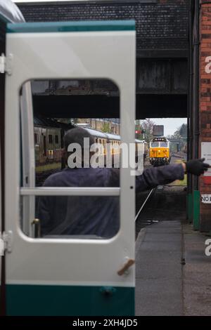 Loughborough (Great Central Railway) shunter guiding class 50 locomotive  50017 Royal Oak on to the front of a train Stock Photo