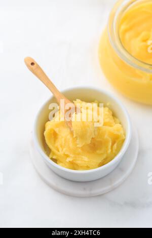 Ghee or clarified butter in jar and bowl. Indian butter. Stock Photo