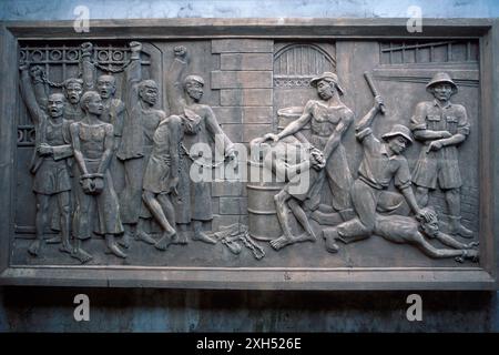 Bas relief of defiant Vietnamese prisoners being tortured by French, Hoa Lo prison, aka Hanoi Hilton, Hanoi, Vietnam Stock Photo