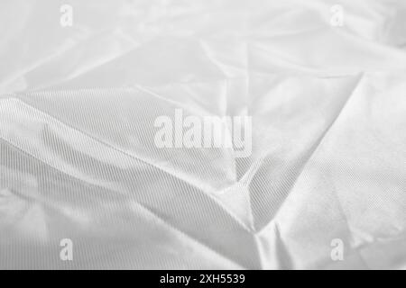 White crumpled satin fabric, abstract background close up Stock Photo