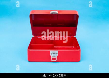 Red first aid kit box, opened,   on blue background, empty copy space for product Stock Photo
