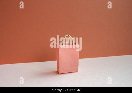 Paper shopping bag on pink and red background Stock Photo
