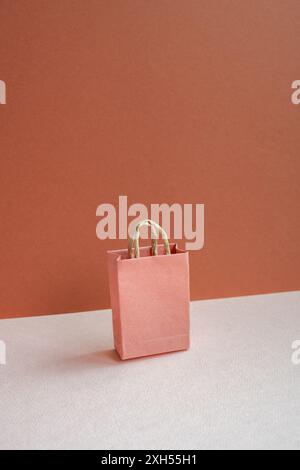 Paper shopping bag on pink and red background Stock Photo