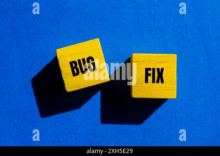 Bug fix message written on yellow wooden cubes with blue background. Conceptual bug fix symbol. Copy space. Stock Photo