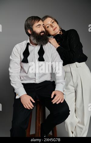 A couple dressed in formal attire poses for a portrait. Stock Photo