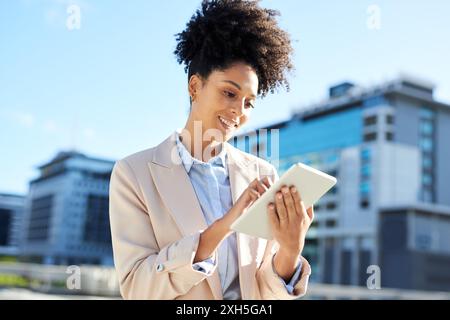 Confident Young Businesswoman Using Tablet in Urban Setting Stock Photo