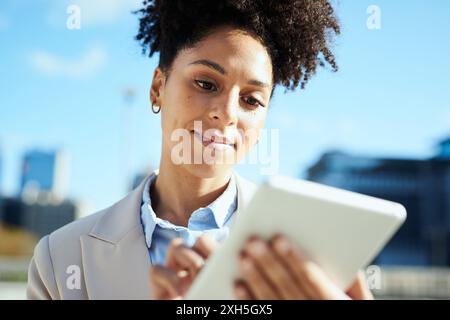 Confident Young Businesswoman Using Tablet in Urban Setting Stock Photo
