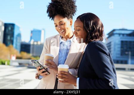 Diverse Group Of Businesswomen Enjoying Coffee And Conversation In Urban Setting Stock Photo