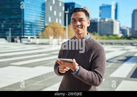 Confident Entrepreneur Using Mobile Device in Modern Urban Environment Stock Photo