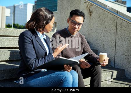 Diverse Business Meeting of Entrepreneurs Discussing Ideas Outdoors in Urban Setting Stock Photo