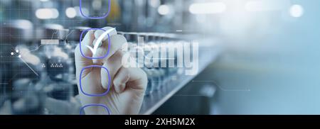a hand marking checkboxes against a blurred industrial background, symbolizing quality control and process management. The digital overlay and futuris Stock Photo
