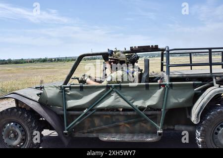 Ukrainian soldiers from the evacuation team of 65th Separate Mechanized brigade drive in the evacuation buggy to Orikhiv. Ukrainian defenders use beach buggies, ATVs (All-terrain Vehicle) and electric bicycles at the front because these vehicles are quieter and harder to see and hear. This gives soldiers on the front line a better chance of avoiding Russian drones and surviving. These small vehicles were no substitute for traditional military vehicles. They lack the firepower and space to carry large numbers of people or cargo, and their lack of armour leaves everyone on board vulnerable. But Stock Photo