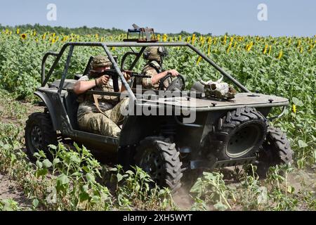 Ukrainian soldiers from the evacuation team of 65th Separate Mechanized brigade seen in the evacuation buggy near Orikhiv. Ukrainian defenders use beach buggies, ATVs (All-terrain Vehicle) and electric bicycles at the front because these vehicles are quieter and harder to see and hear. This gives soldiers on the front line a better chance of avoiding Russian drones and surviving. These small vehicles were no substitute for traditional military vehicles. They lack the firepower and space to carry large numbers of people or cargo, and their lack of armour leaves everyone on board vulnerable. But Stock Photo