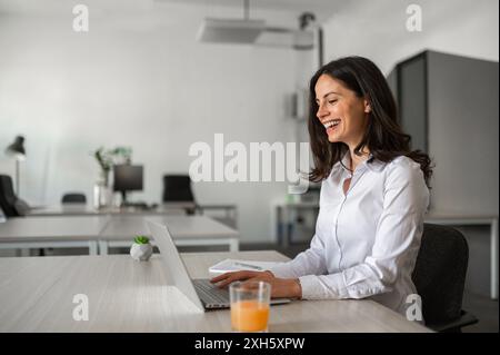 Joyfull office worker typing on computer Stock Photo