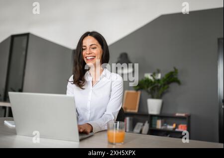 Portrait of young brunnete working in bright modern office space Stock Photo