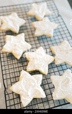 Star shaped iced sugar cookies on a rack Stock Photo