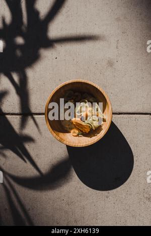 Artistic dish with vegetables and sauce in a wooden bowl Stock Photo