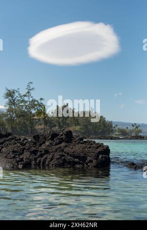 Lens-shaped lenticular cloud formation on sunny day in Hilo, Hawaii. Stock Photo