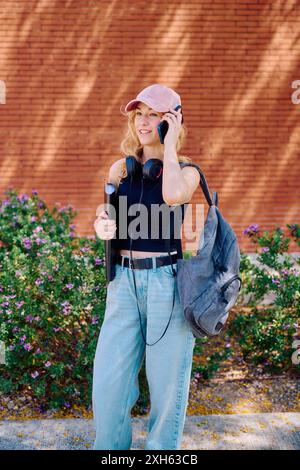 Student talking on phone outside Stock Photo