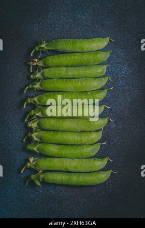 Green peas on dark blue background Stock Photo