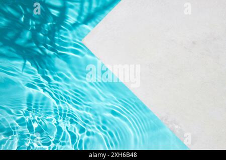 Poolside Serenity. A serene image showcasing a clean pool with crystal blue water and a white poolside. Stock Photo
