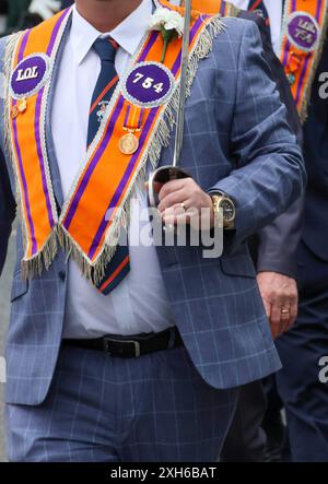 Lurgan, County Armagh, Northern Ireland.12 Jul 2024. The Twelfth of July is marked by Orange Order parades across Northern Ireland. Lurgan District left their headquarters at Brownlow House before parading up the town to the war memorial ahead of the main County Armagh demonstration being held in Killylea this year.The parades across Northern Ireland mark the victory of William of Orange over James at the Battle of the Boyne in 1690. Credit: CAZIMB/Alamy Live News. Stock Photo