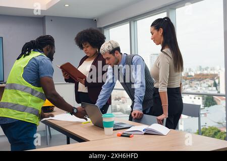 Group of Entrepreneurs People busy working on table, they are reviewing documents and analyzing plans of work that are on table, there is Woman with A Stock Photo