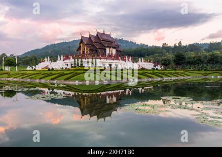 Royal Pavilion, its reflection in pond and cloudy pinkish sky in the morning at Royal Flora Ratchaphruek  park. Chiang Mai, Thailand Stock Photo